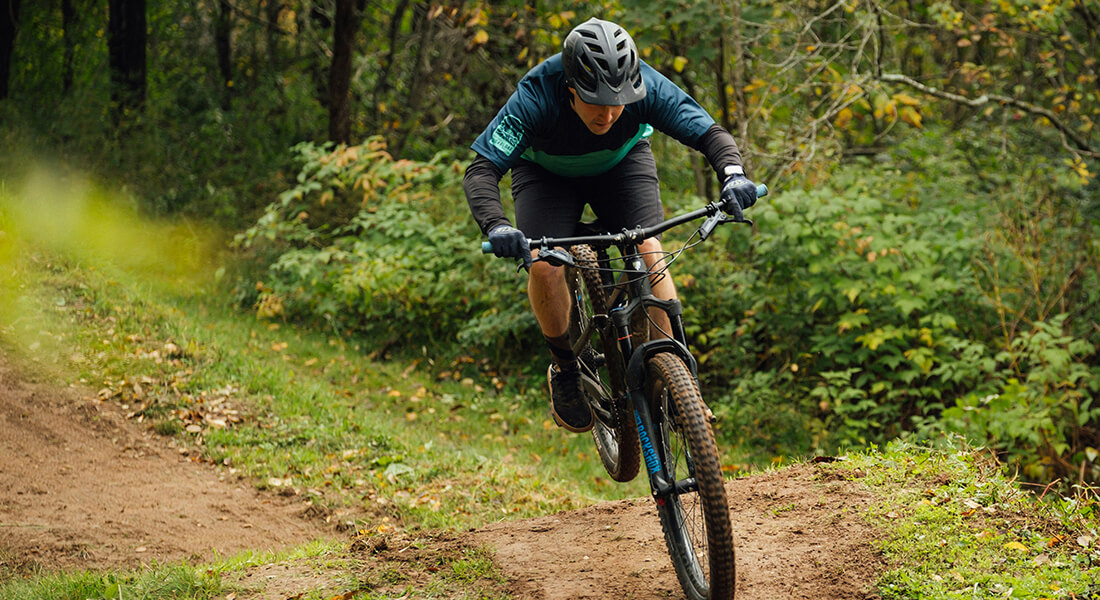 Photo of cyclists in forest. Photo: Tim Foster on Unsplash